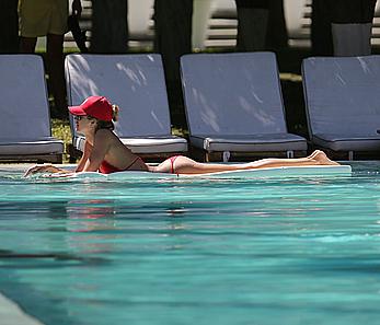 Lauren Stoner in red bikini poolside in Miami