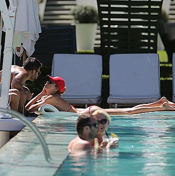 Lauren Stoner in red bikini poolside in Miami