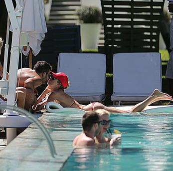 Lauren Stoner in red bikini poolside in Miami