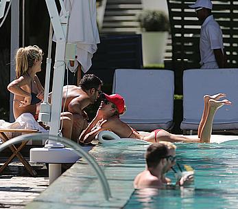 Lauren Stoner in red bikini poolside in Miami