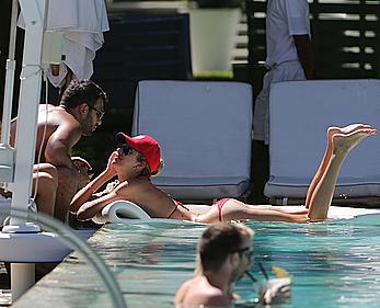 Lauren Stoner in red bikini poolside in Miami