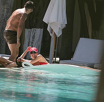 Lauren Stoner in red bikini poolside in Miami