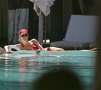 Lauren Stoner in red bikini poolside in Miami