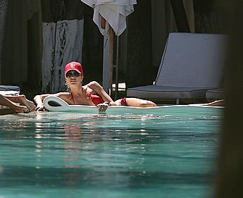 Lauren Stoner in red bikini poolside in Miami