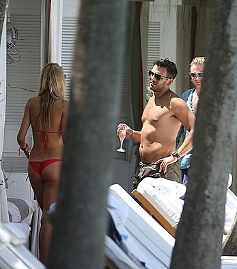 Lauren Stoner in red bikini poolside in Miami