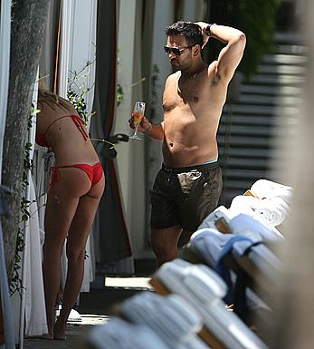 Lauren Stoner in red bikini poolside in Miami