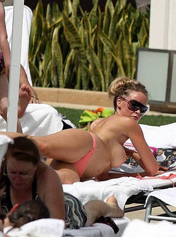 Busty Lauren Pope sunbathing topless on a beach