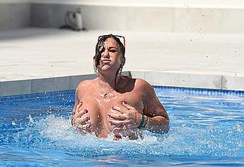 Lisa Appleton boobs out in a pool paparazzi shots