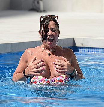 Lisa Appleton boobs out in a pool paparazzi shots