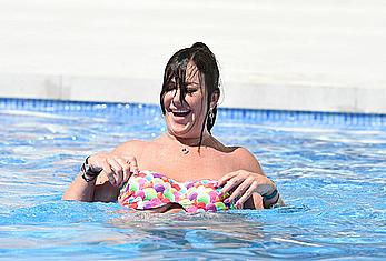 Lisa Appleton boobs out in a pool paparazzi shots