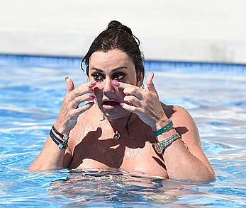 Lisa Appleton boobs out in a pool paparazzi shots