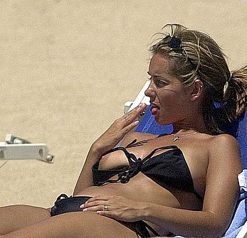 Louise Redknapp sunbathing topless on a beach