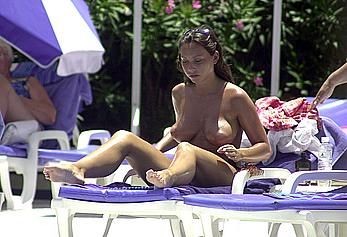 British Lucinda Rhodes-Flaherty sunbathing topless poolside