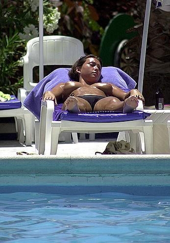 British Lucinda Rhodes-Flaherty sunbathing topless poolside