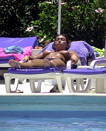 British Lucinda Rhodes-Flaherty sunbathing topless poolside