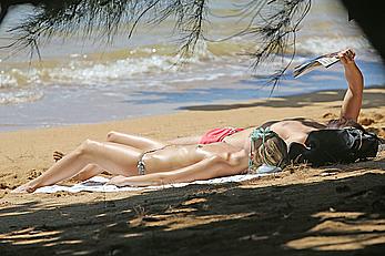 Margot Robbie sunbathing topless on the beach in Hawaii