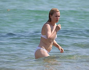 Melissa George pokies in white wet bikinii at a beach in St Tropez