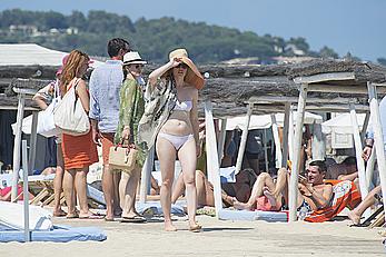 Melissa George pokies in white wet bikinii at a beach in St Tropez