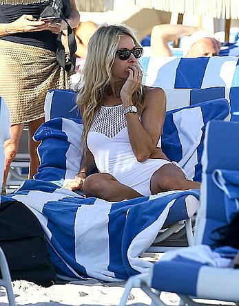 Melissa Odabash in white swimsuit enjoys a day on the beach in Miami