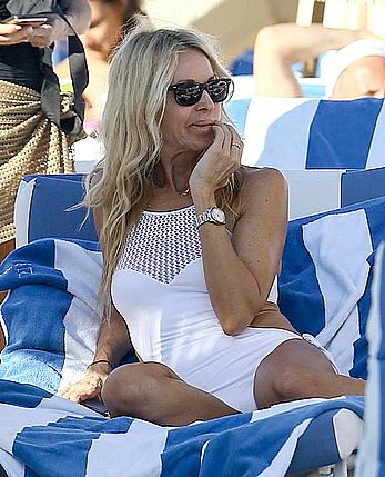 Melissa Odabash in white swimsuit enjoys a day on the beach in Miami