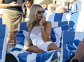 Melissa Odabash in white swimsuit enjoys a day on the beach in Miami