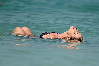 Michelle Hunziker in bikini at a beach