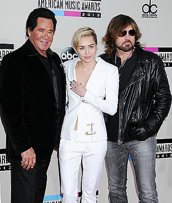 Miley Cyrus without bra under white jacket at 2013 American Music Awards