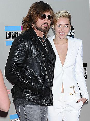 Miley Cyrus without bra under white jacket at 2013 American Music Awards