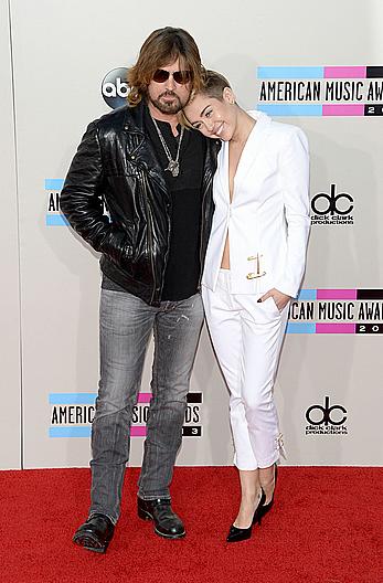 Miley Cyrus without bra under white jacket at 2013 American Music Awards