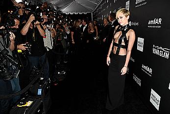 Miley Cyrus posing almost topless at amfAR LA Inspiration Gala in Hollywood