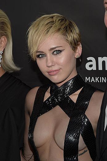 Miley Cyrus posing almost topless at amfAR LA Inspiration Gala in Hollywood