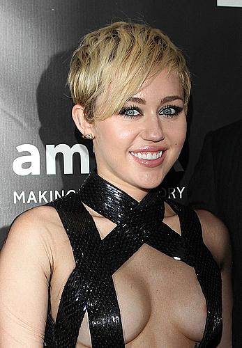 Miley Cyrus posing almost topless at amfAR LA Inspiration Gala in Hollywood