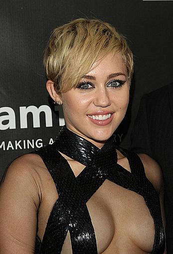 Miley Cyrus posing almost topless at amfAR LA Inspiration Gala in Hollywood