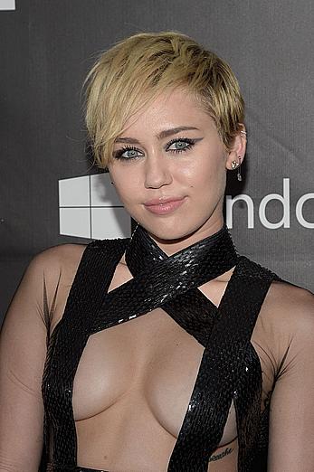 Miley Cyrus posing almost topless at amfAR LA Inspiration Gala in Hollywood