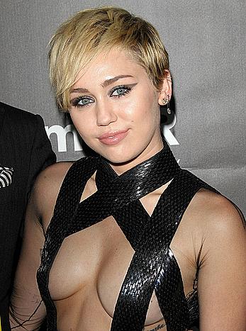 Miley Cyrus posing almost topless at amfAR LA Inspiration Gala in Hollywood