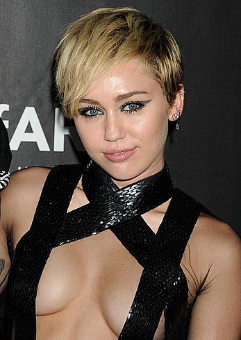 Miley Cyrus posing almost topless at amfAR LA Inspiration Gala in Hollywood