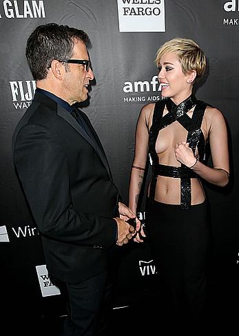 Miley Cyrus posing almost topless at amfAR LA Inspiration Gala in Hollywood