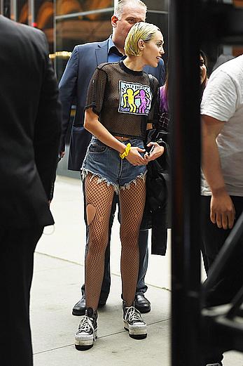 Miley Cyrus in a see through shirt and shorts