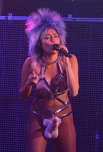 Miley Cyrus with fake nude tits and penis on a stage 