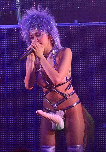 Miley Cyrus with fake nude tits and penis on a stage 