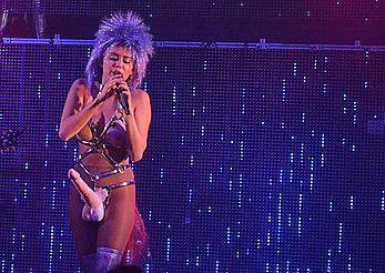 Miley Cyrus with fake nude tits and penis on a stage 