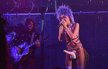 Miley Cyrus with fake nude tits and penis on a stage 