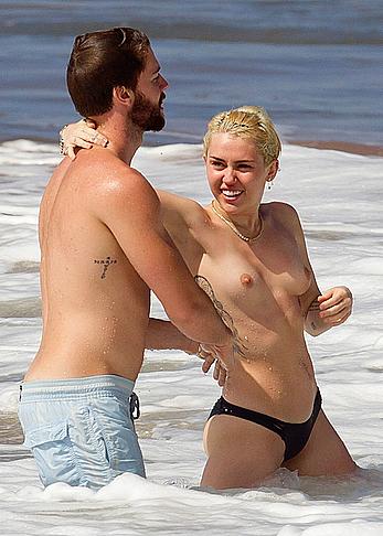 Miley Cyrus caught topless on a beach in Hawaii