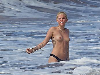 Miley Cyrus caught topless on a beach in Hawaii