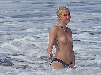 Miley Cyrus caught topless on a beach in Hawaii