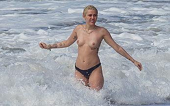 Miley Cyrus caught topless on a beach in Hawaii