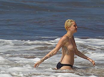 Miley Cyrus caught topless on a beach in Hawaii