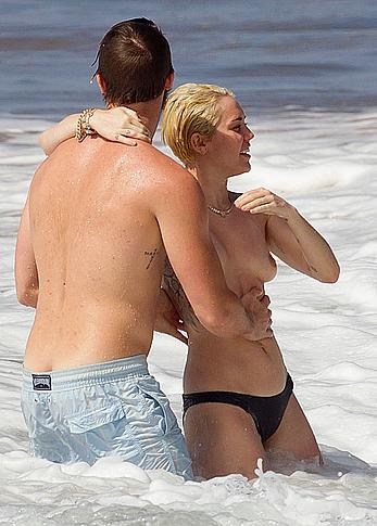 Miley Cyrus caught topless on a beach in Hawaii