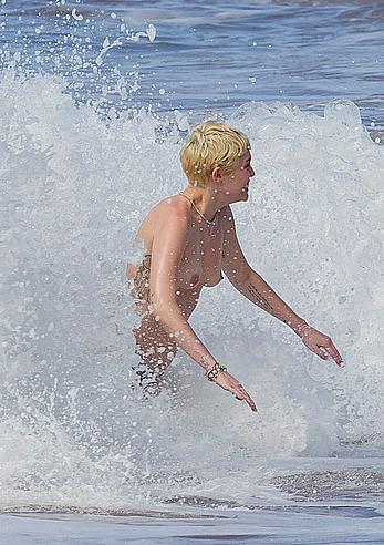 Miley Cyrus caught topless on a beach in Hawaii