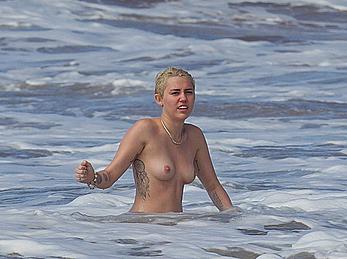 Miley Cyrus caught topless on a beach in Hawaii